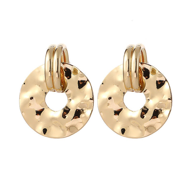 Gold hoop earrings with a textured design on a white background